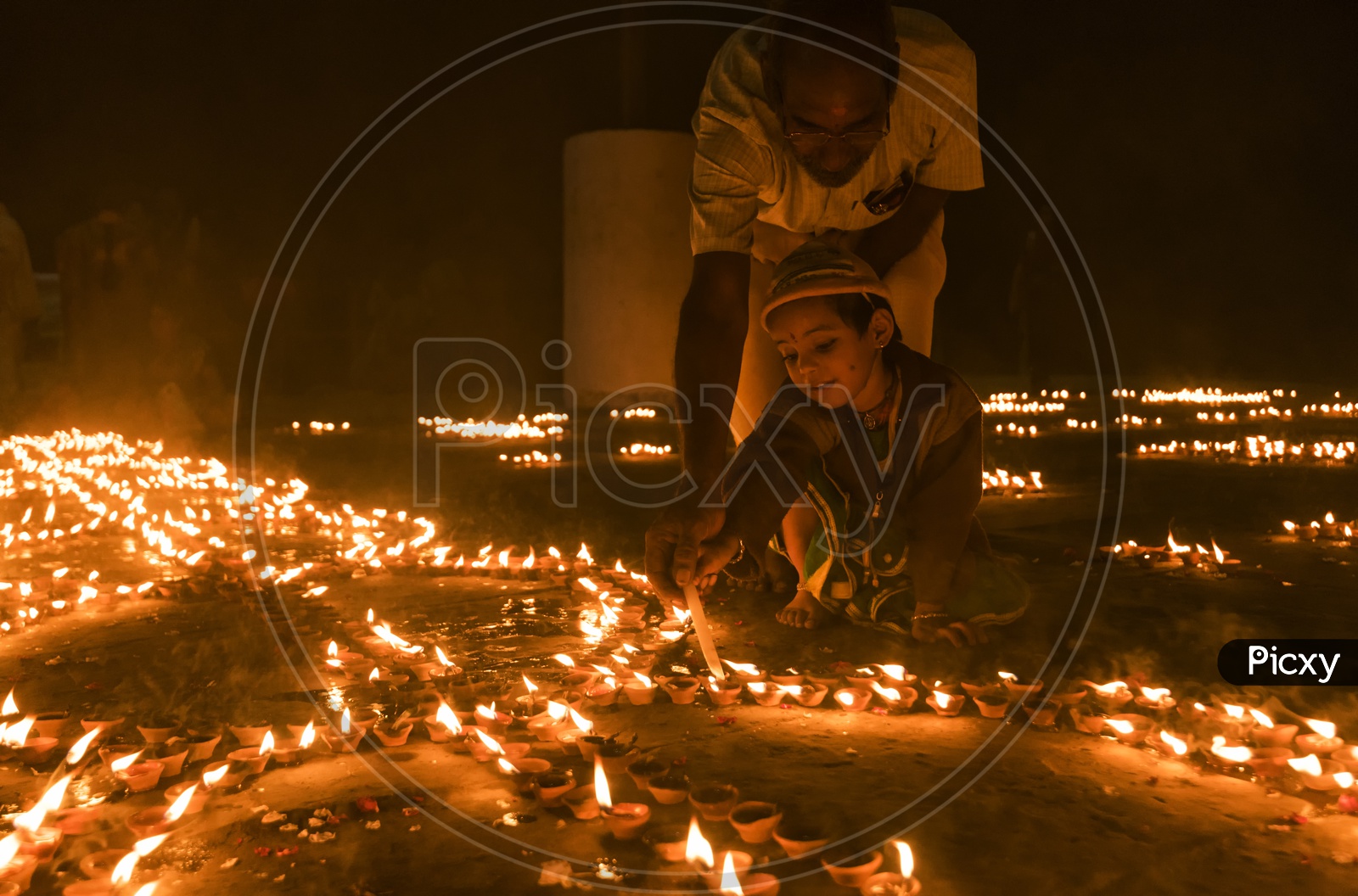 A Small Child  Lighting the Dias in River Bank of ganga River In varanasi