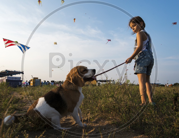 A  Girl Child With her Pet Dog At Kite Festival in Pondicherry