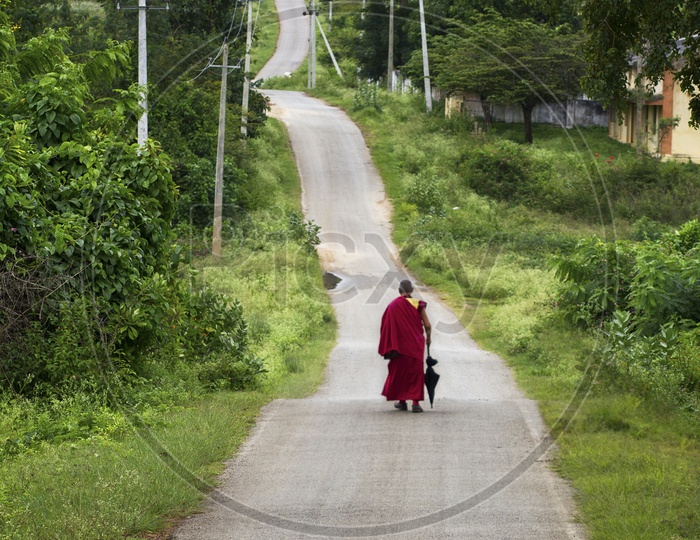 Monk walking along on the road