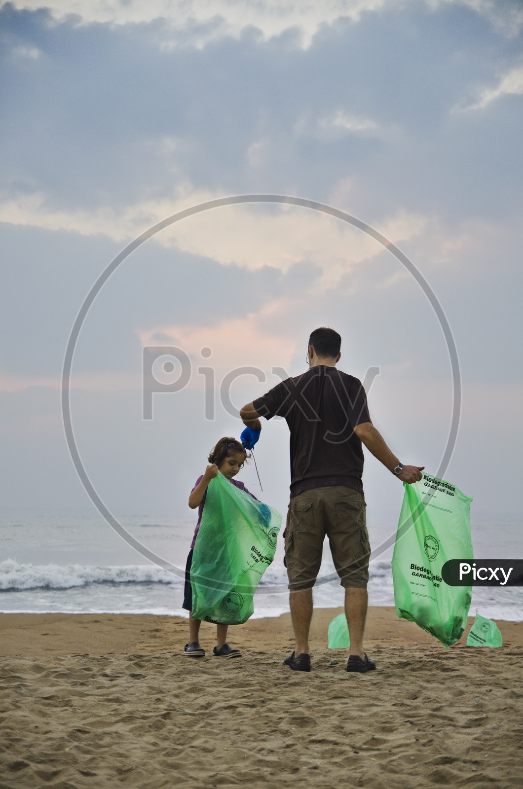 Father and Daughter holding the trashbags