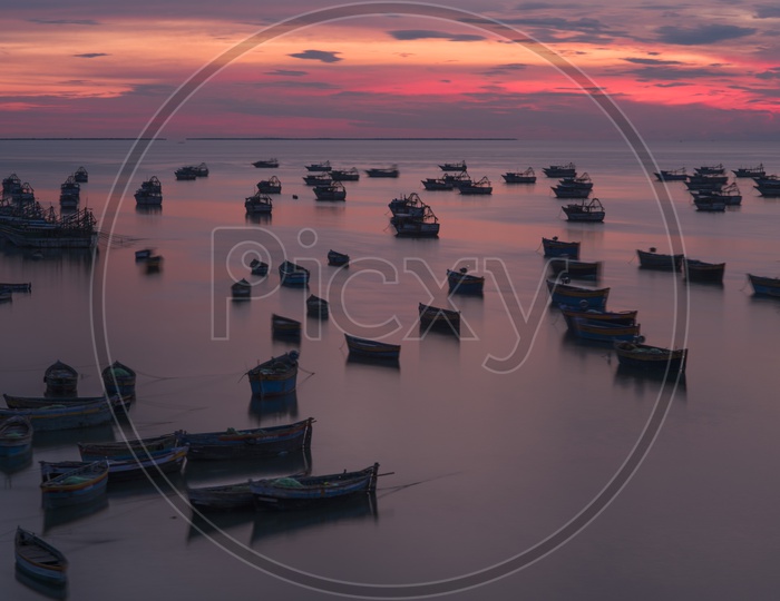 A Silhouette of  Fishing Boats over a Sunset