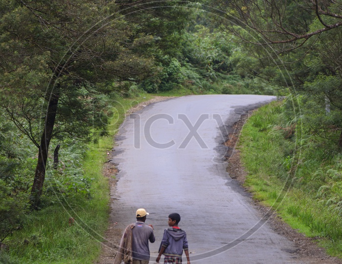 Two men walking along the road