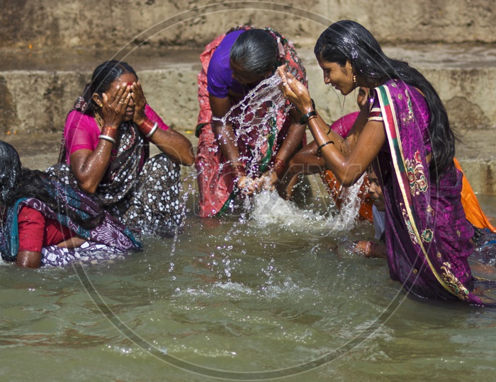 Indian Woman Taking a Holi Bath in River Godavari in Nasik