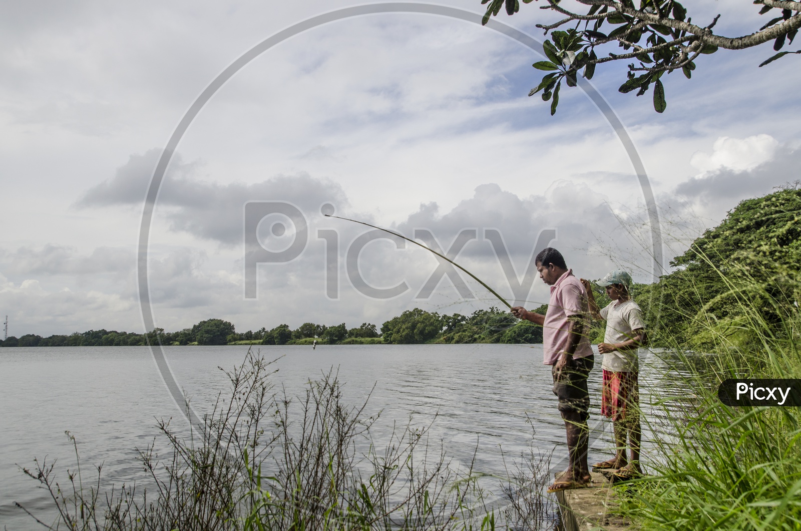 Two men fishing by the lake