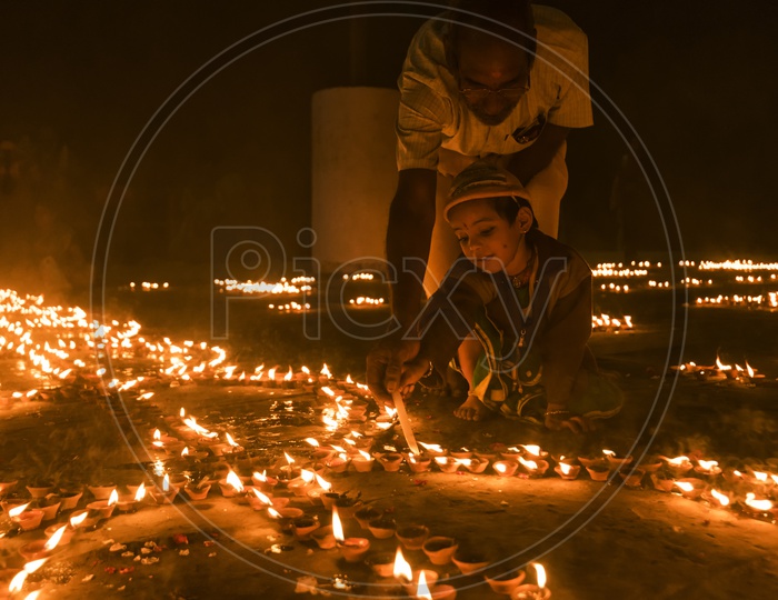 A Small Child  Lighting the Dias in River Bank of ganga River In varanasi