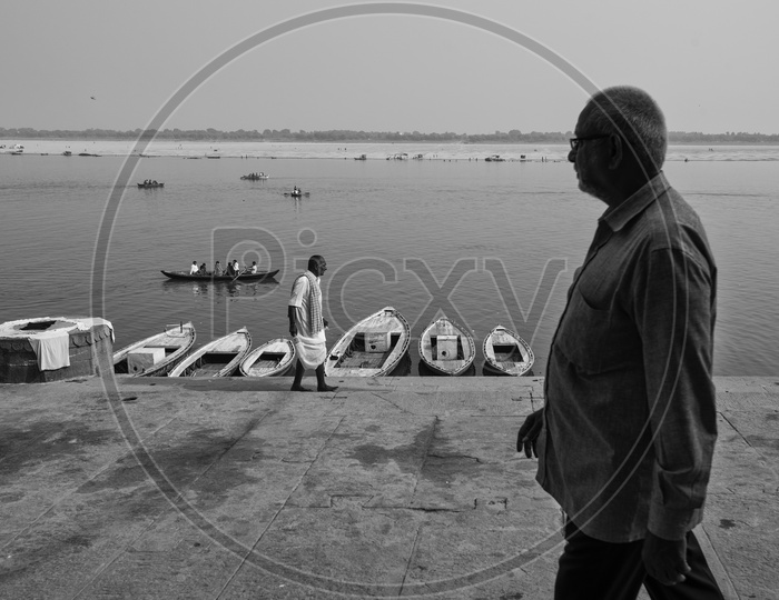 A Man Walking On The River banks of Ganga in varanasi