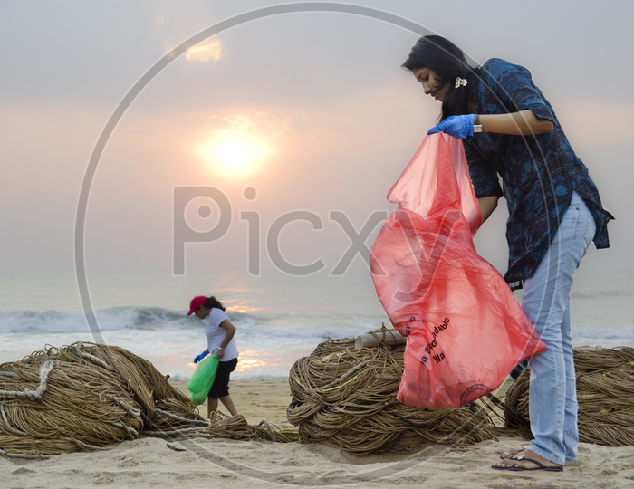 Girls helping to keep the beach clean
