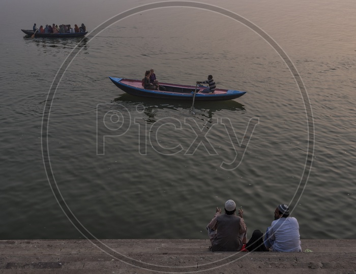 Two muslim Friends Sitting On the Stairs Of Ganga River bank in varanasi