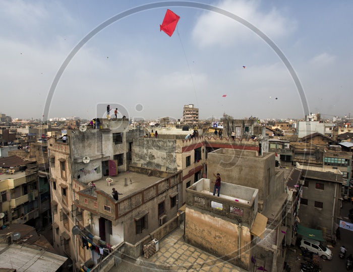 Indians Flying Kites On Their House Terrace in Gujarat