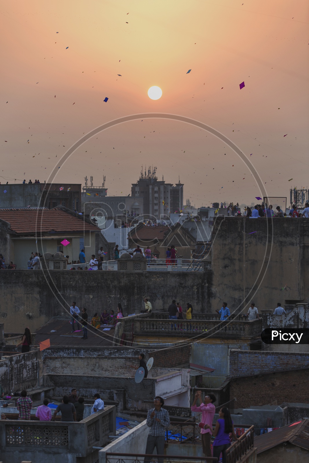 Indian People Flying Kites on their House Terraces in Gujarat Over a Beautiful Sunset in Sky