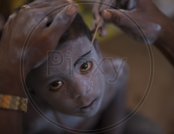 Indian boy getting ready with makeup  For Dussera Celebrations in tamil nadu