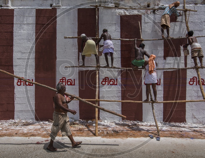 Workers painting a Hindu temple in Tamil Nadu