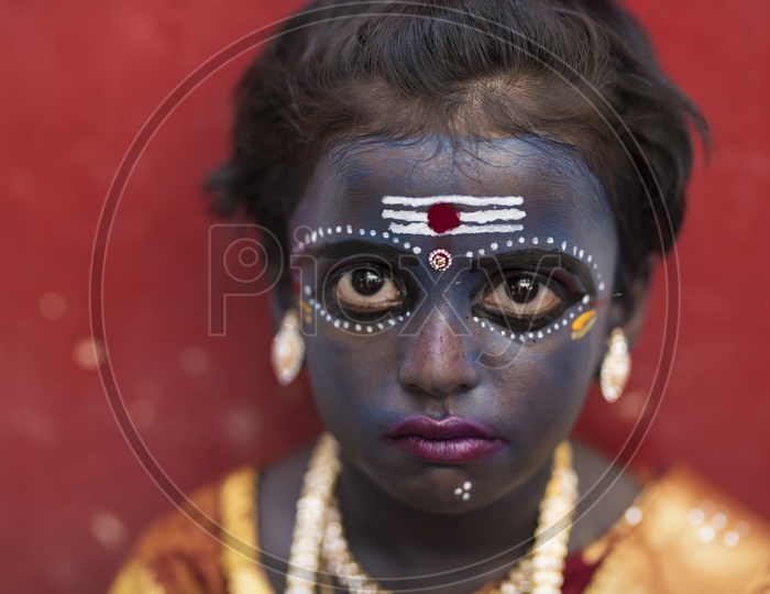 A Girl Hindu Devotee makeup as Kaali maata in Dussera celebrations in tamil Nadu