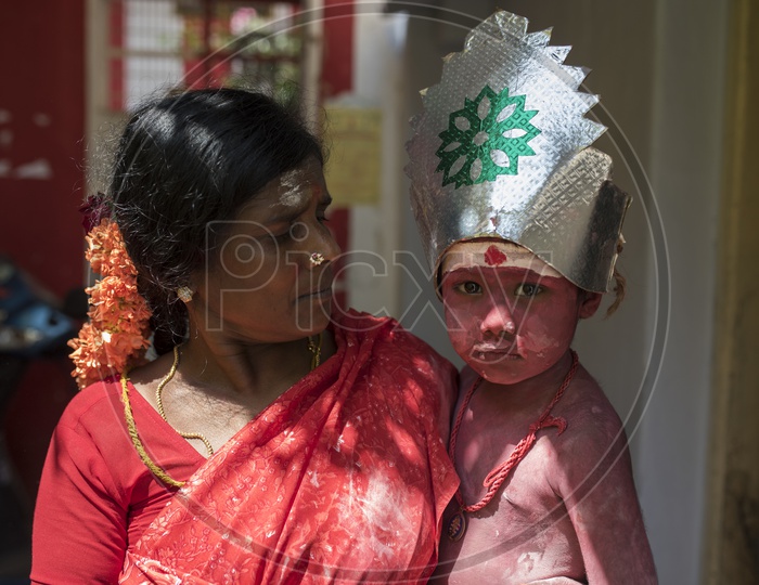 A mother Carrying her Child in Dussera Celebrations in tamil Nadu
