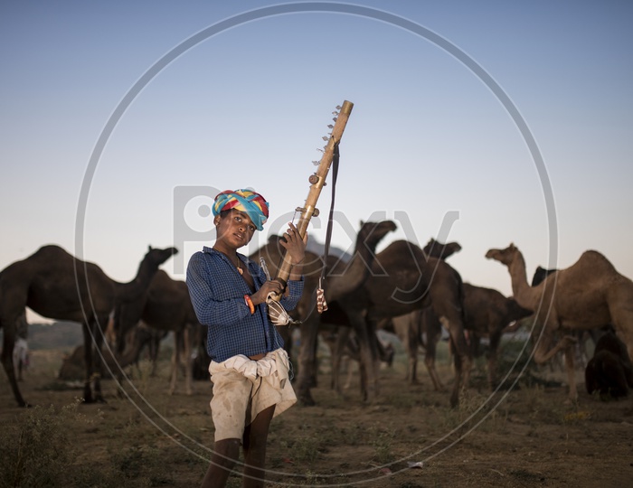 A Rajasthan Local Boy With traditional Music Instruments In Pushkar Fair