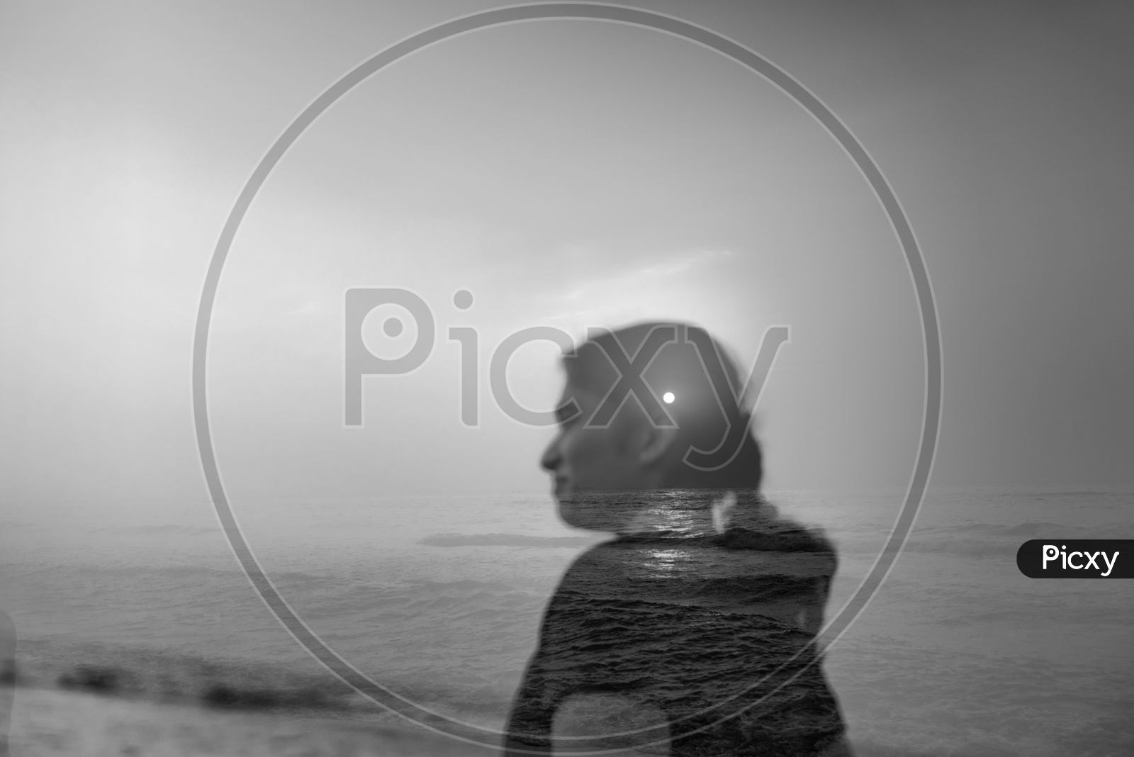 Double Exposure of a Indian Woman Over a Sea Sunrise