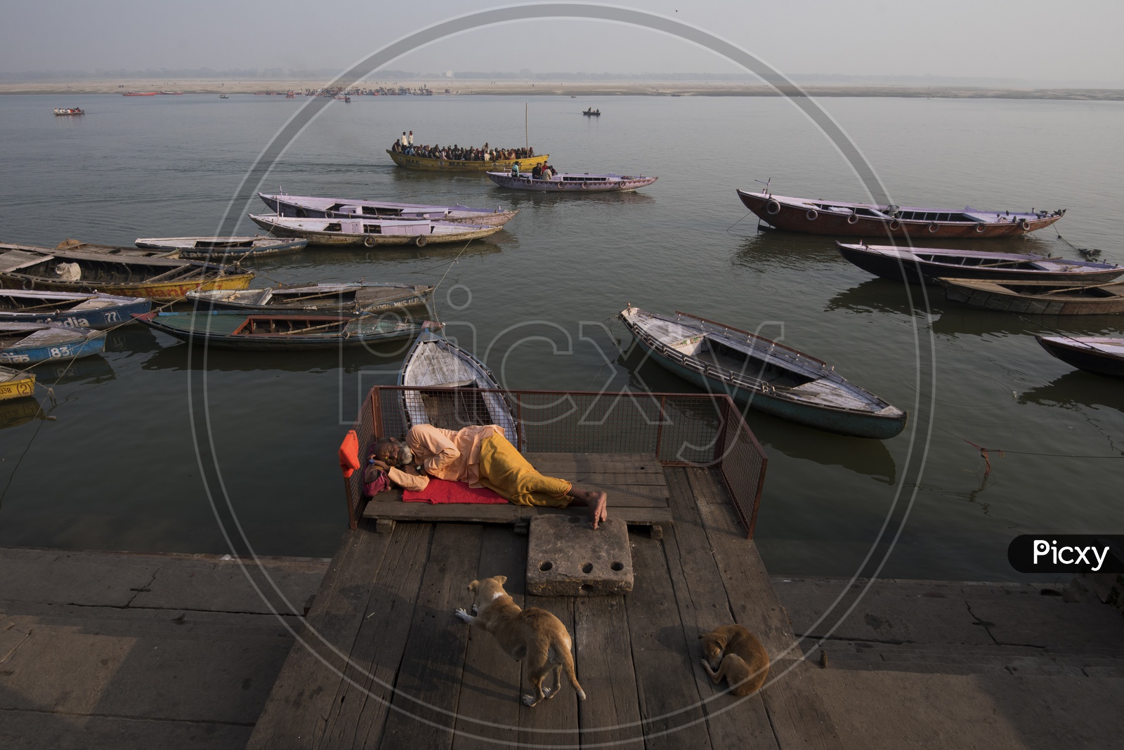 An old man Seeping on the River banks of Varanasi