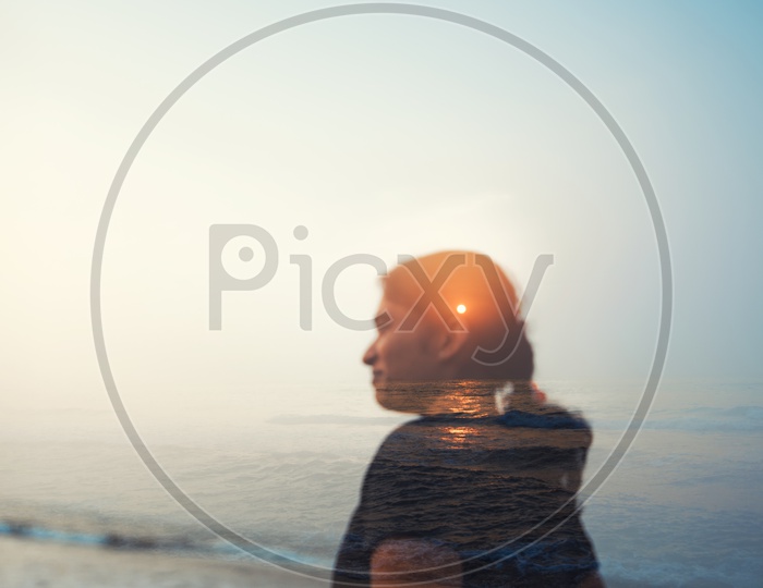 Double Exposure of a Indian Woman Over a Sea Sunrise