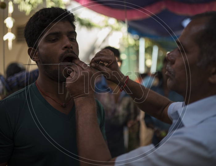 Indian Hindu Devotees Piercing Their Cheeks With Trishul As a Coustom in Dussera Celebrations in Tamil Nadu