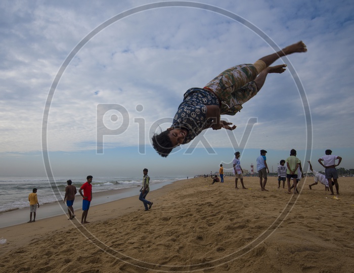 Young People Performing Gymnastics in marina beach