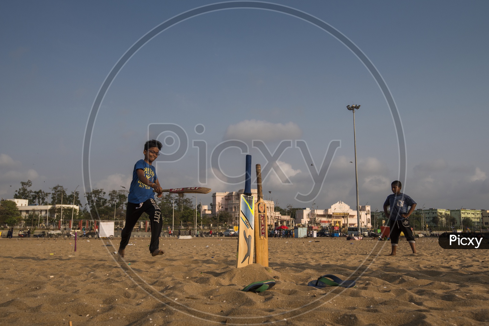 Children Playing Cricket in beach