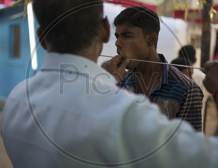 Indian Hindu Devotees Piercing Their Cheeks With Trishul As a Coustom in Dussera Celebrations in Tamil Nadu