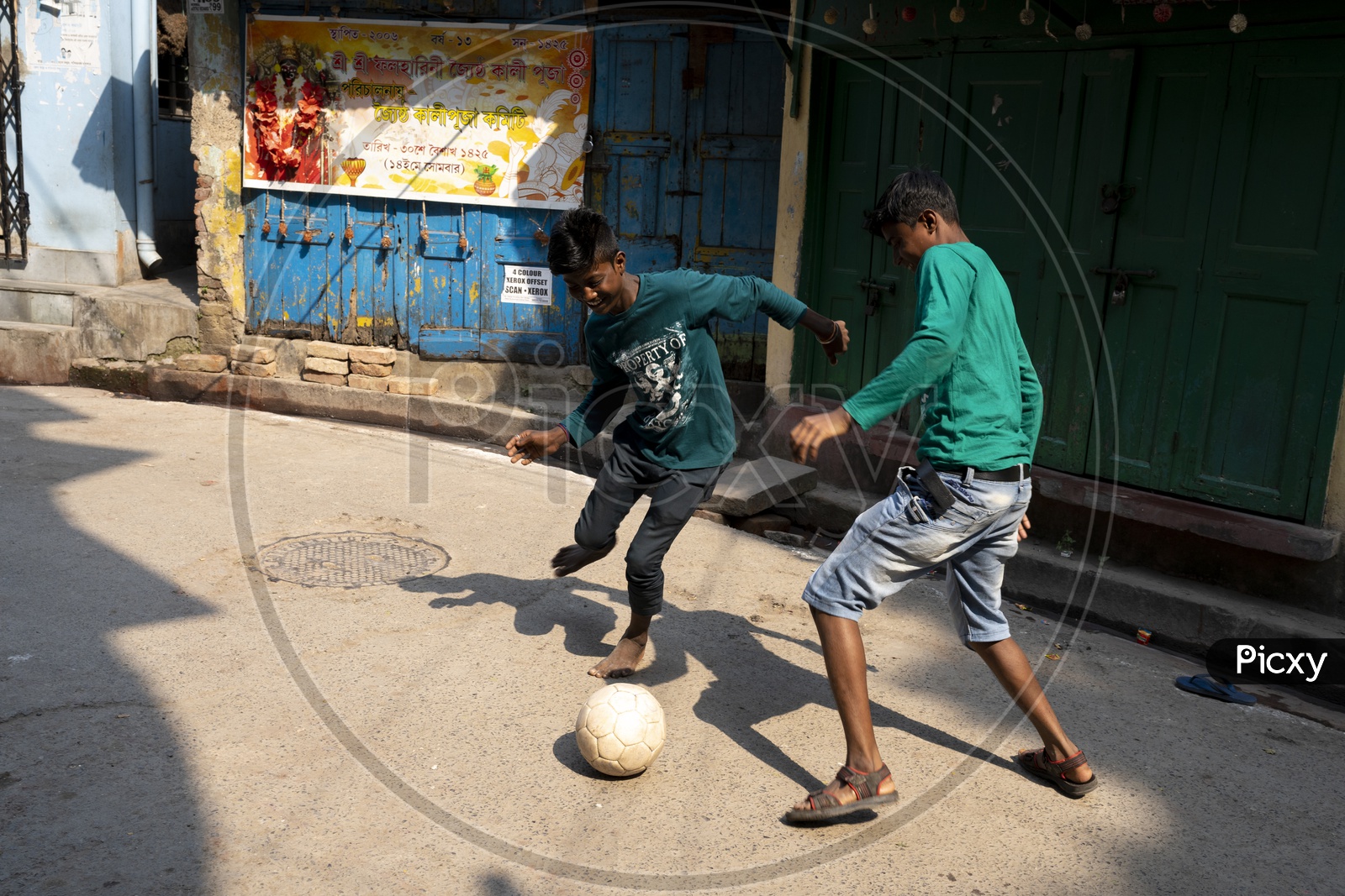 Indian kids playing football in the streets of Kolkata
