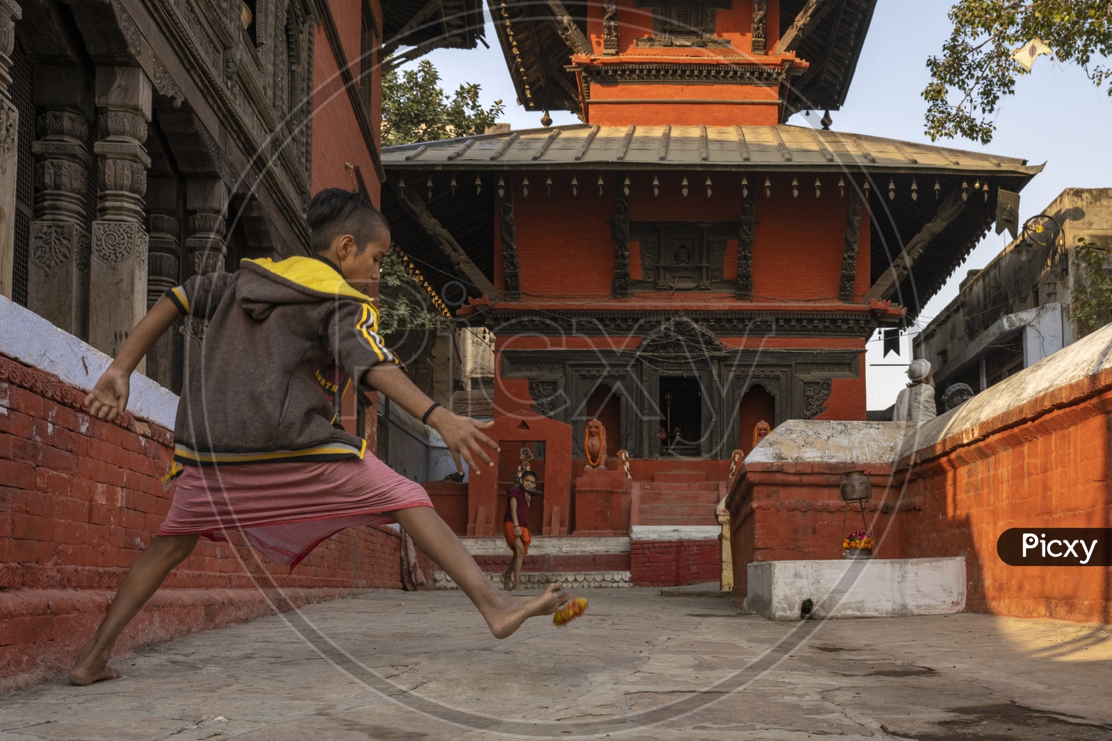 Image Of Indian Child Priests Playing In A Temple Compound In Varanasi 