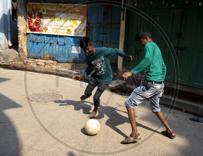 Indian kids playing football in the streets of Kolkata