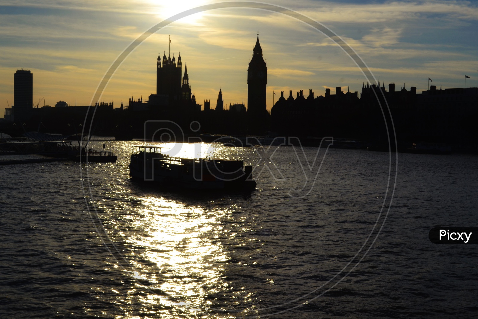 Silhouetted River bus on Thames against Palace of Westminster