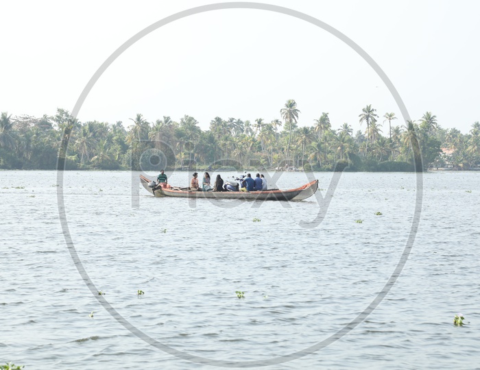 people traveling in small boat in kerala