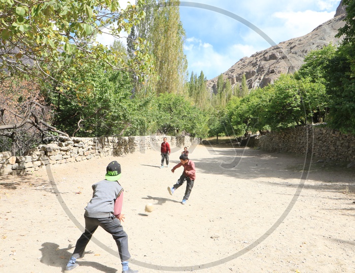 school kids playing football game in leh