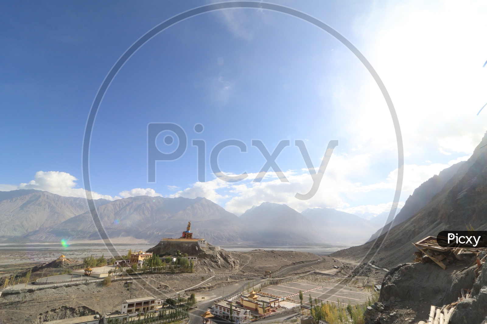 Buddha Statue with beautiful mountains in the background in leh