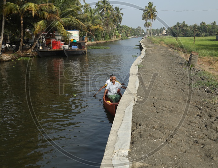 people traveling in small boat in kerala