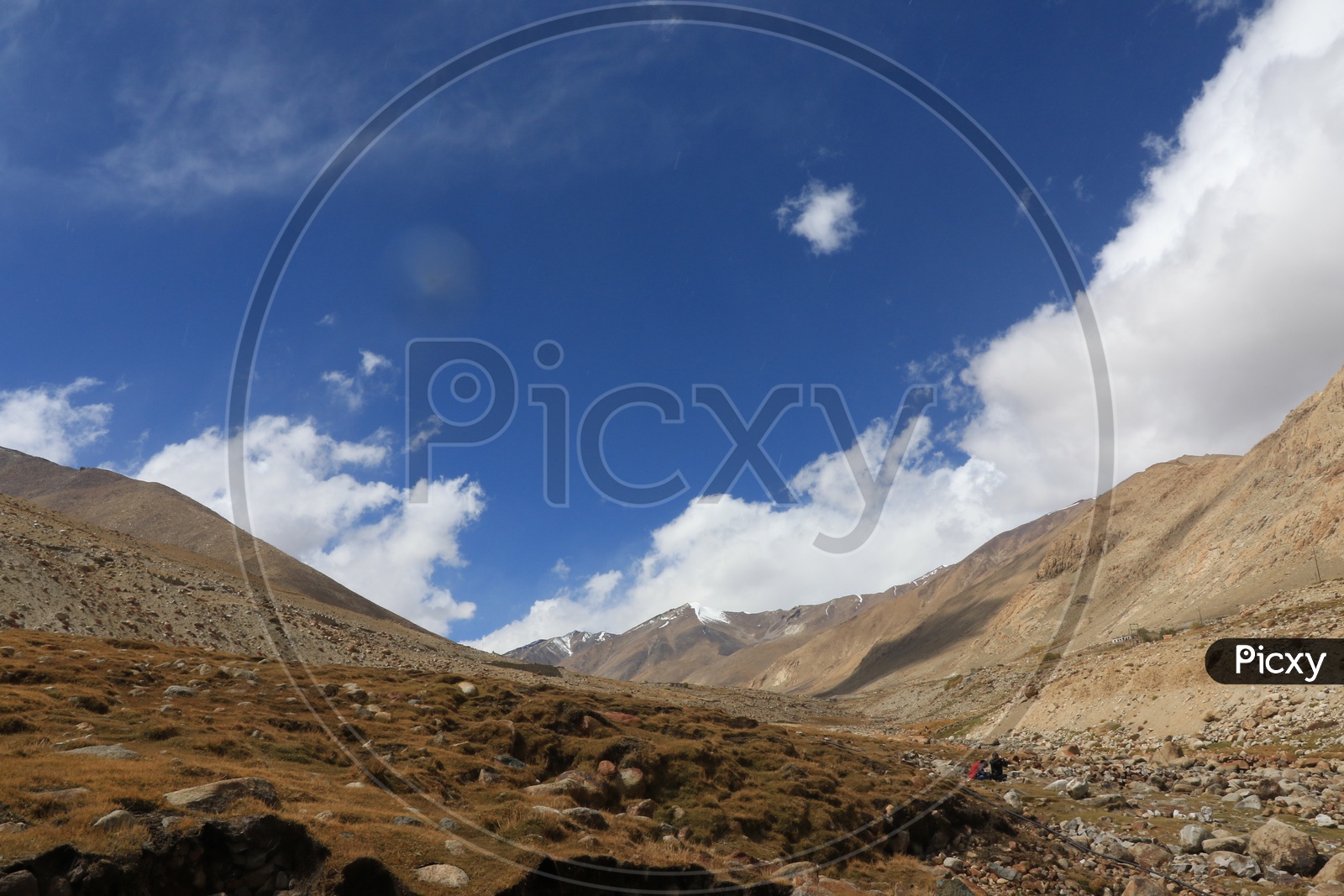 Beautiful Landscape of Snow Capped Mountains of Leh with huge clouds