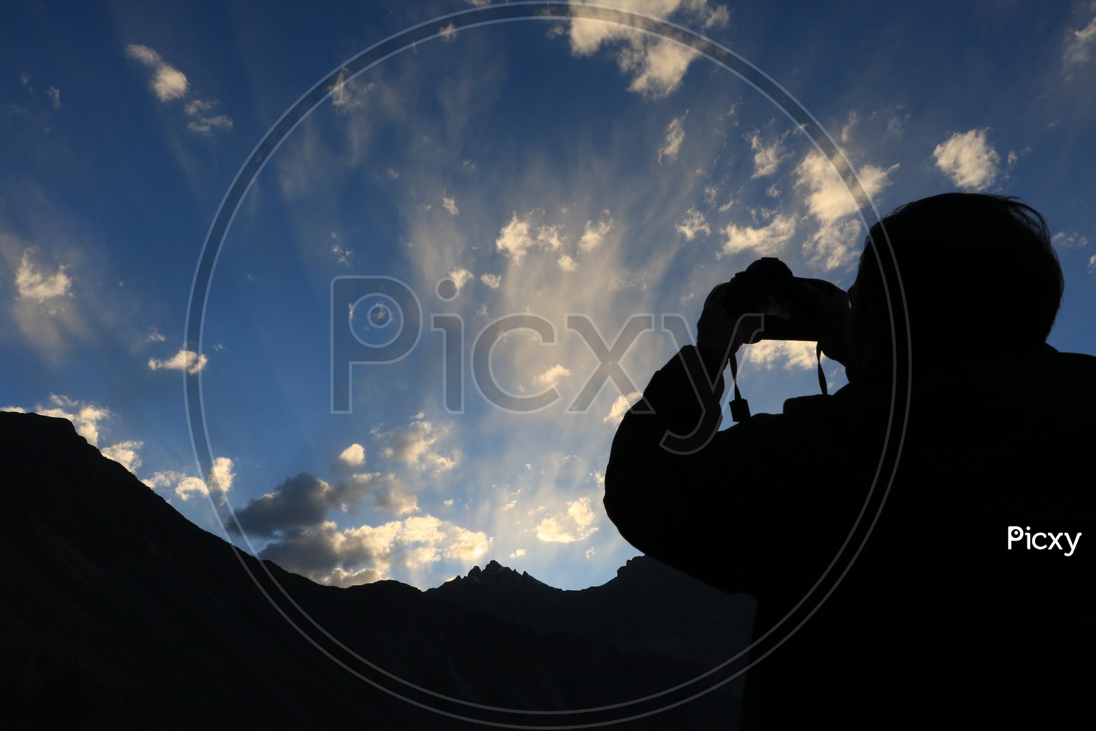 Man taking a picture of the Sky