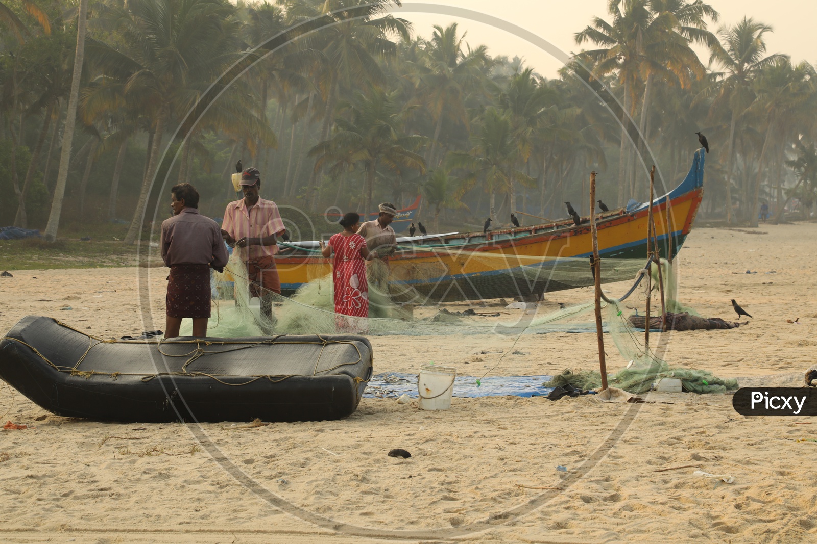 fishers with fishing net in the beach