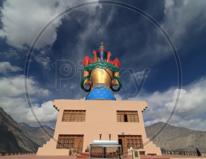Back view of Buddha statue with beautiful mountains of leh