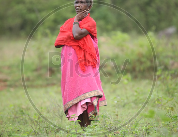 photograph of old women standing in agricultural fields