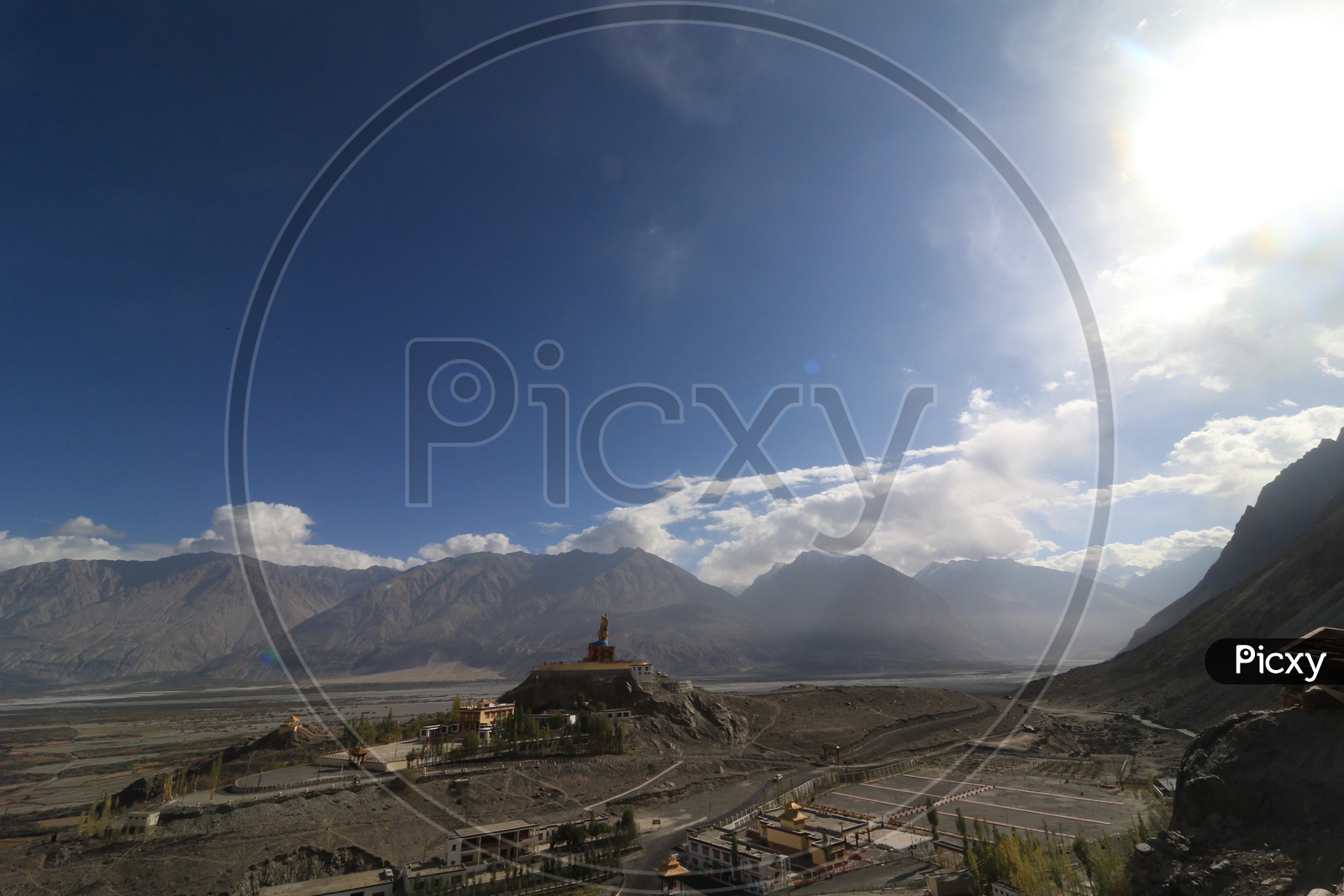 Buddha Statue with beautiful mountains in the background in leh