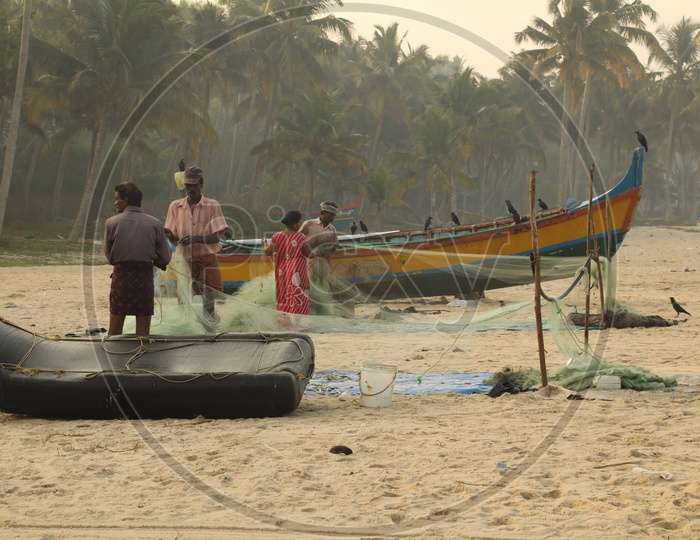 fishers with fishing net in the beach