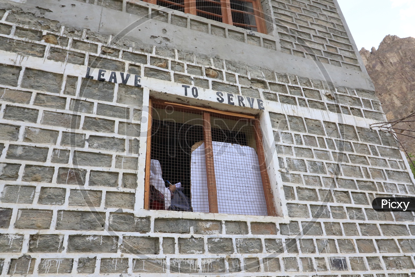 Women sitting near window and writing