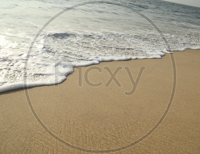 Water wave on beach sand