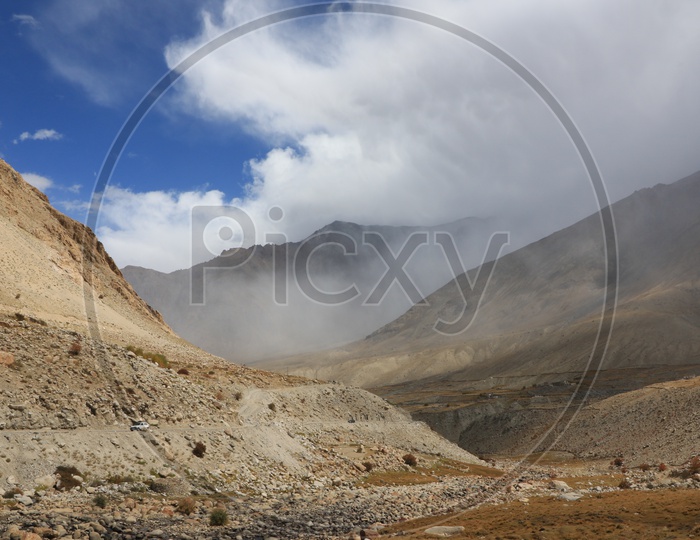 Beautiful Landscape of Snow Capped Mountains of Leh with huge clouds