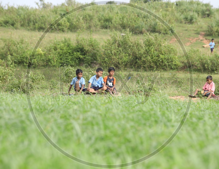 kids sitting in the field