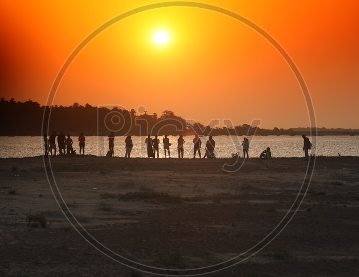 Silhouette Of People Standing on a River side in Rural Area