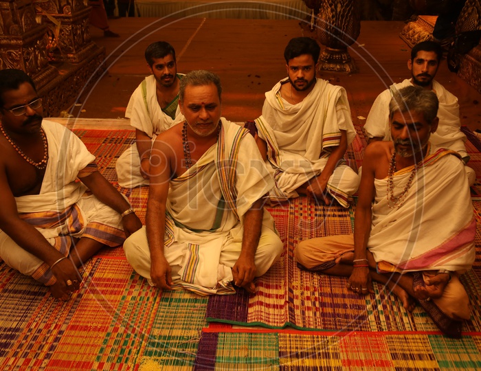 Indian Hindu  Priests Sitting on Traditional Mats