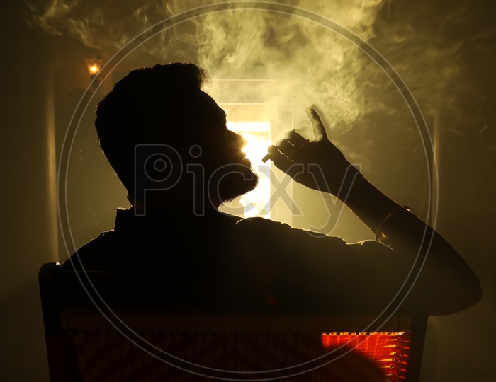 Silhouette of a Man Smoking Cigarette