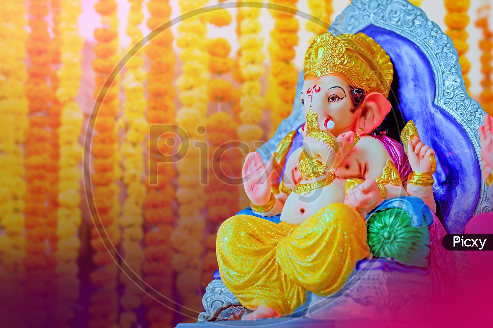 Lord Ganesha Idol with flowers in the background