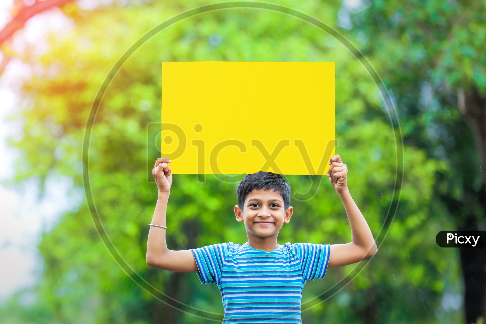 Indian Boy Showing an Empty Placard With Smile on Face